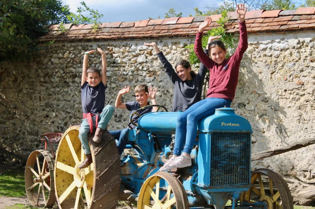 Children on a tractor at the Château de Saint-Fargeau farm