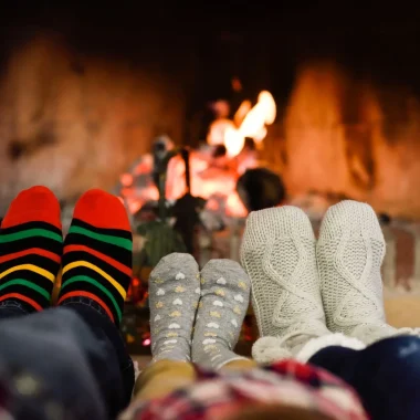 family in front of the fireplace in winter