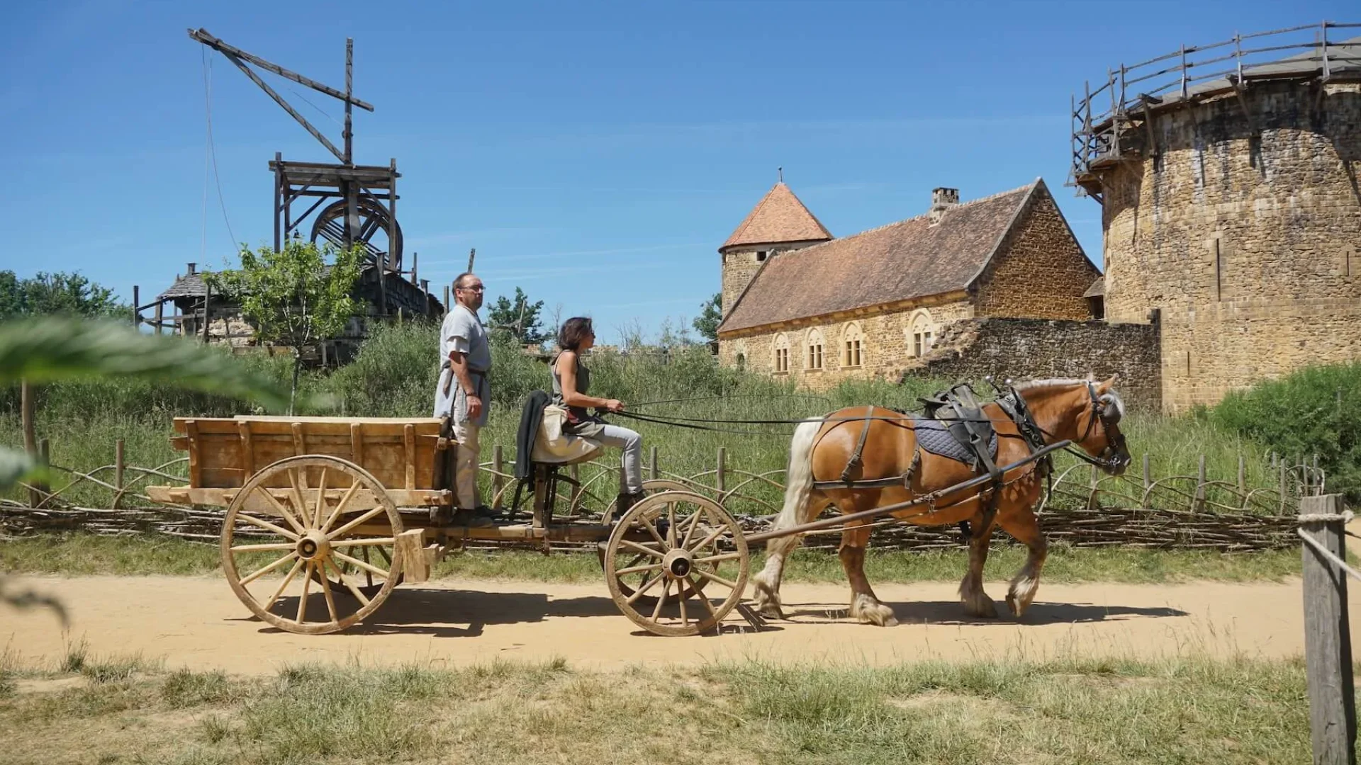 Arpège harnessed to the tumper passes in front of the Guédelon castle